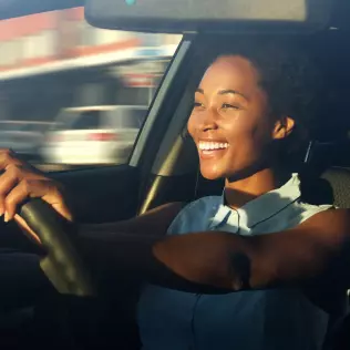 A lady driving a long term car rental car with Pace Car Rental